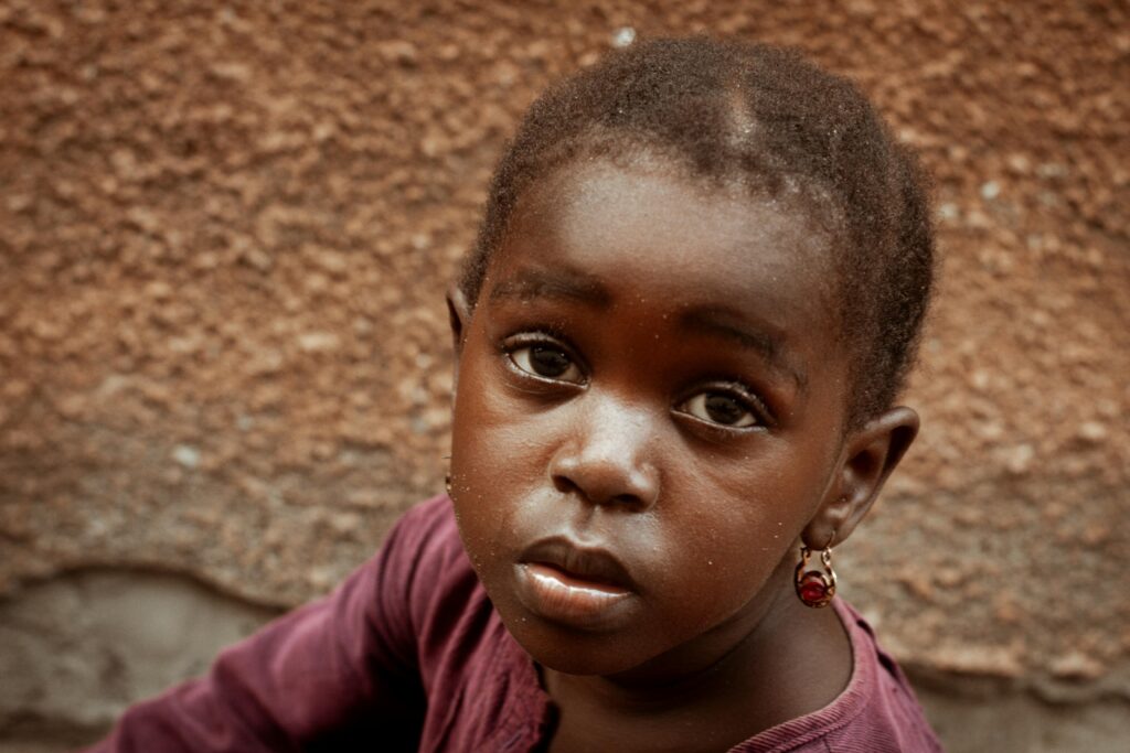 pexels-photo-3802189-3802189 Captivating portrait of a young girl with a serious expression in Tanzania
